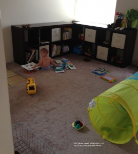 awake & enjoying his playroom, searching for the perfect read