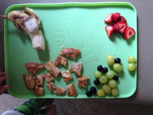 half a banana, french toast on local/organic whole wheat bread, grapes & strawberries